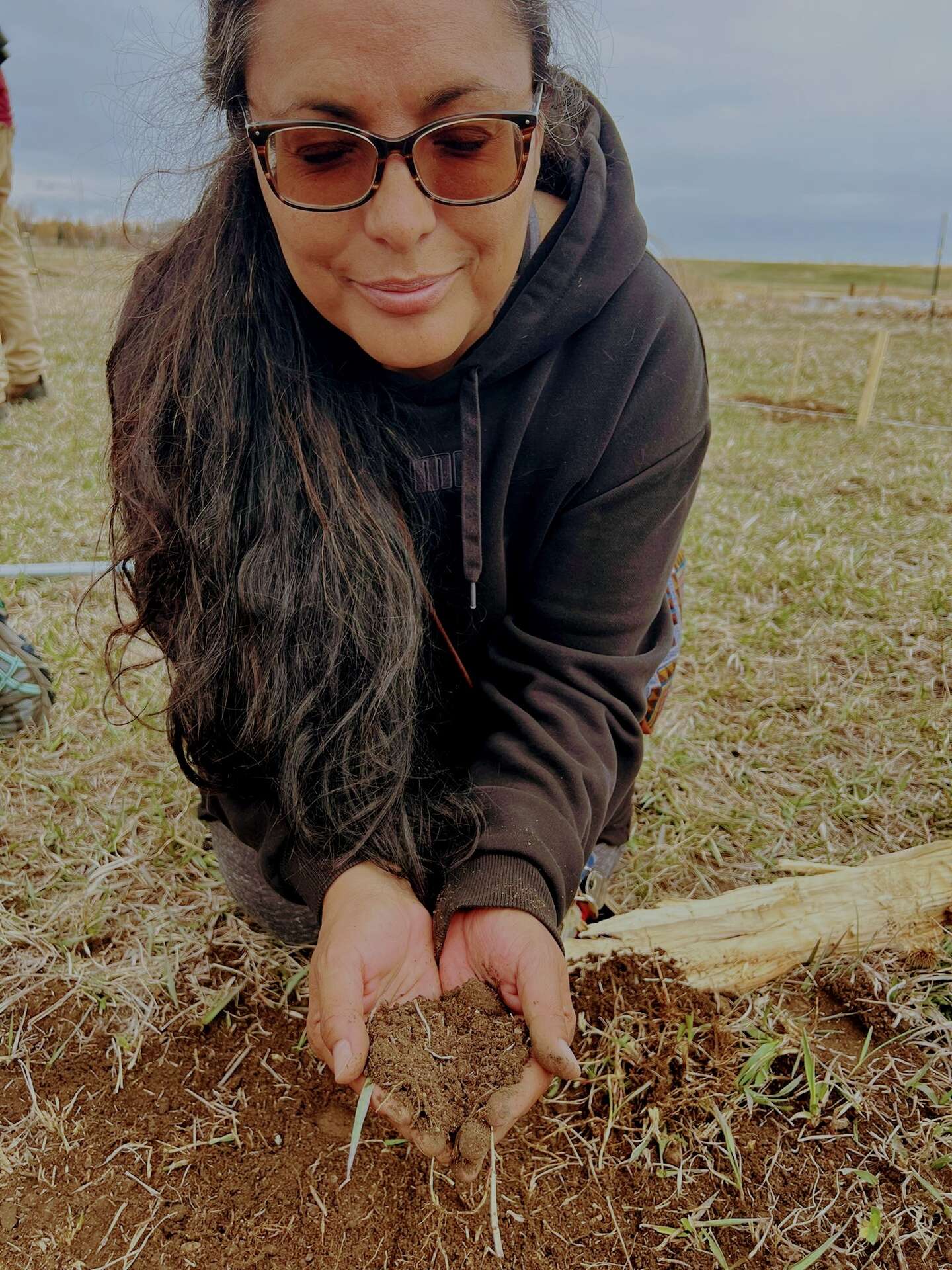 Beverly's hands holding soil
